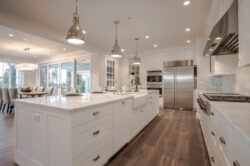 White Farmhouse Kitchen with Wood Floors and Silver Fixtures
